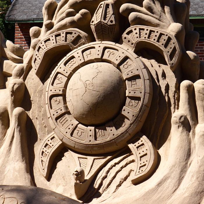Beautiful sand sculpture with the Earth and the signs of the zodiac