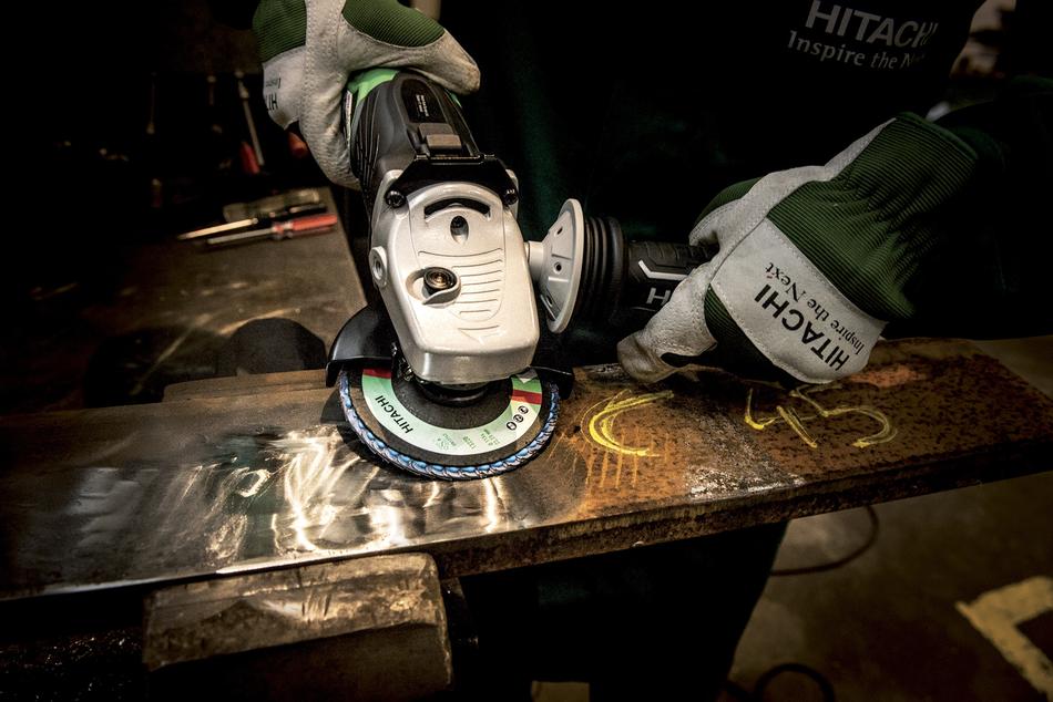 worker with a grinder at the shipyard
