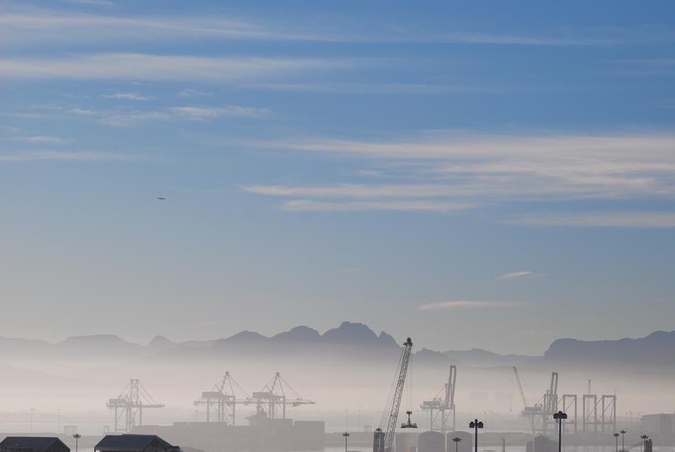Beautiful landscape with the cranes in fog and mountains on background