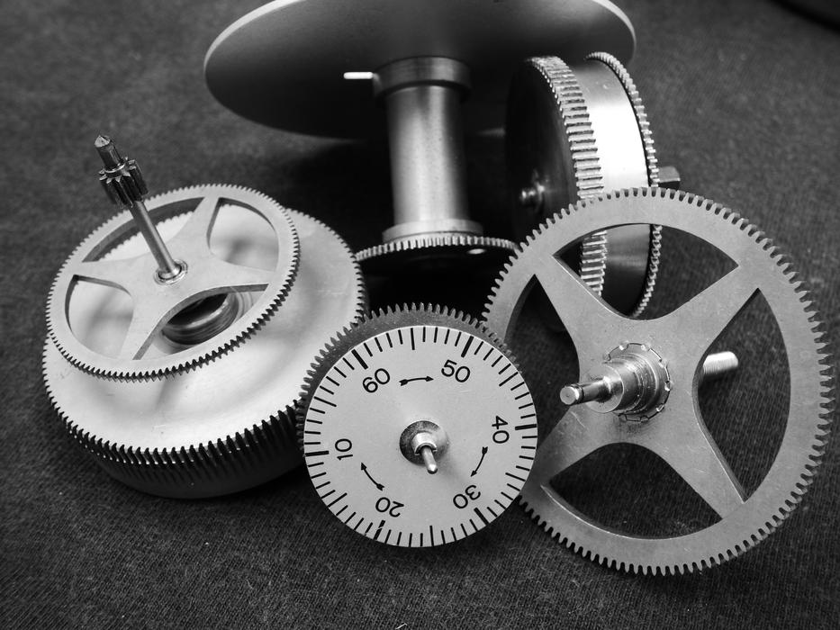 Black and white photo of the shiny gears, with the signs