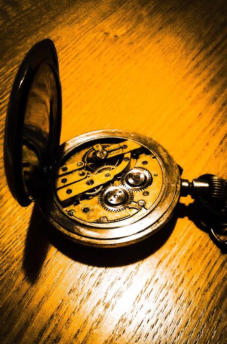Watch Old Vintage on a wooden surface in yellow light