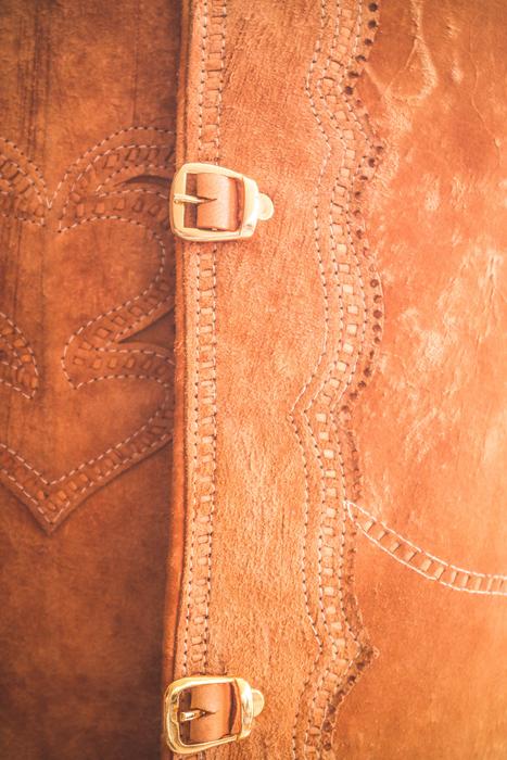 Close-up of the beautiful, brown leather clothes, with the buckle, in light