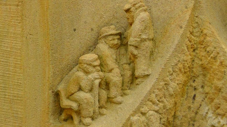 Stone Figures as a sculpture on the wall
