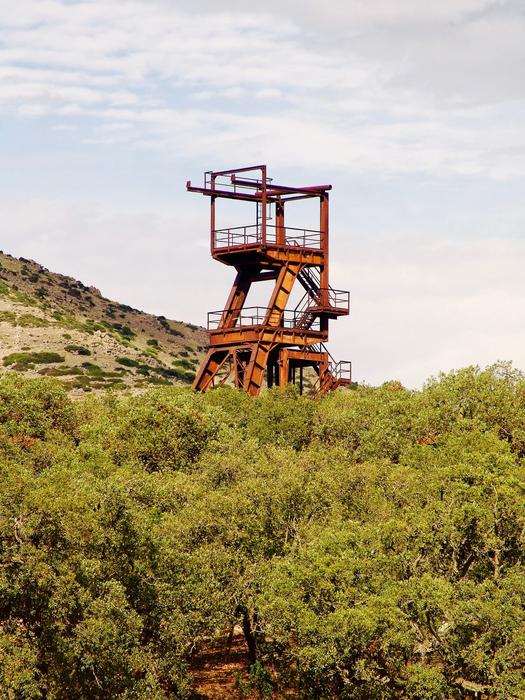 Old Rusty headframe on forested slope