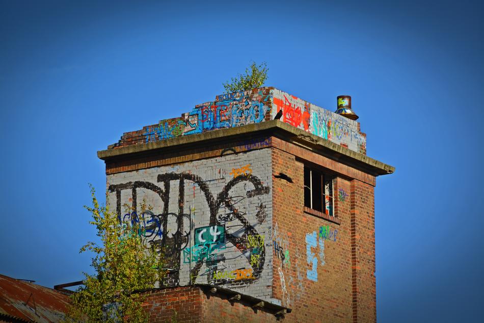 graffiti on the tower of an abandoned factory