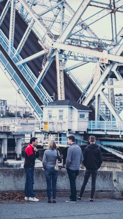 people are talking on the background of the raised bridge