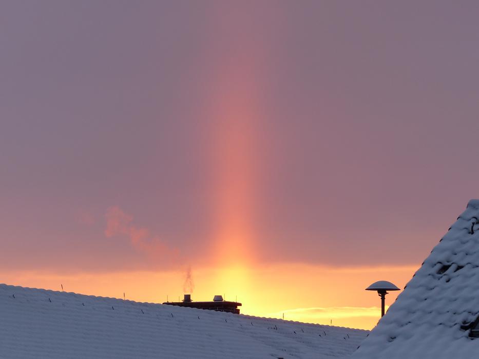 Beautiful houses with white snow, at colorful and beautiful sunrise in the sky
