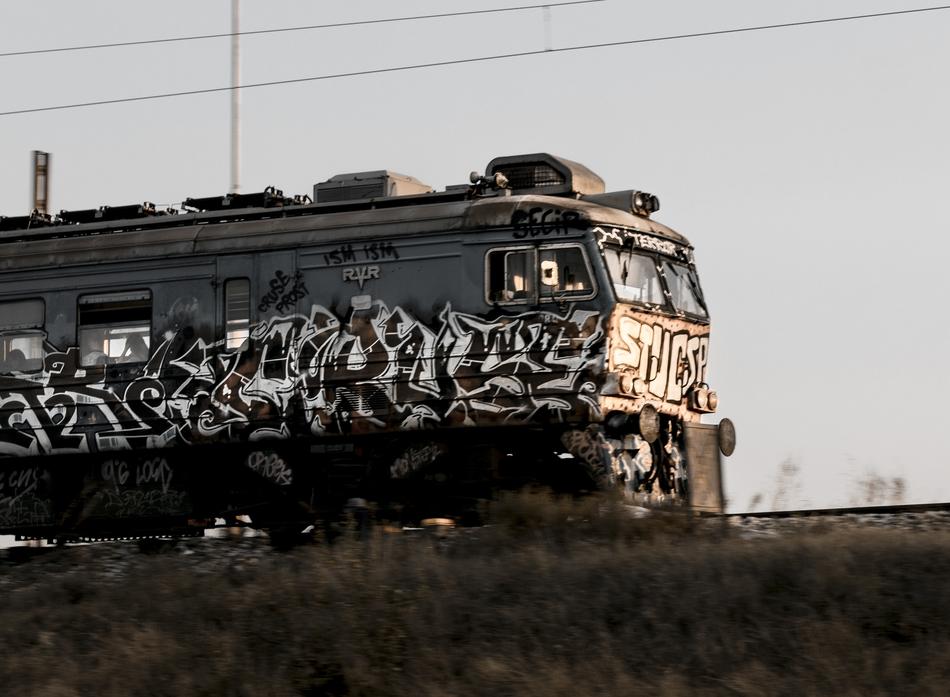 Beautiful, retro, train with black and white graffiti, on the railway in Serbia