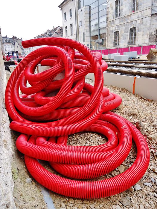 Red hose, on the road, among the buildings