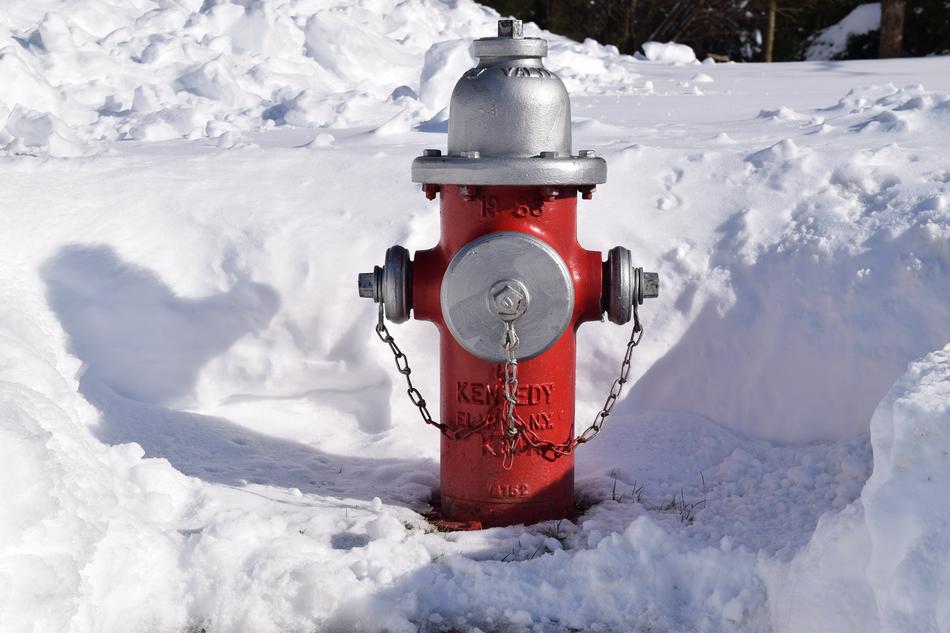 red fire hydrant on snow background