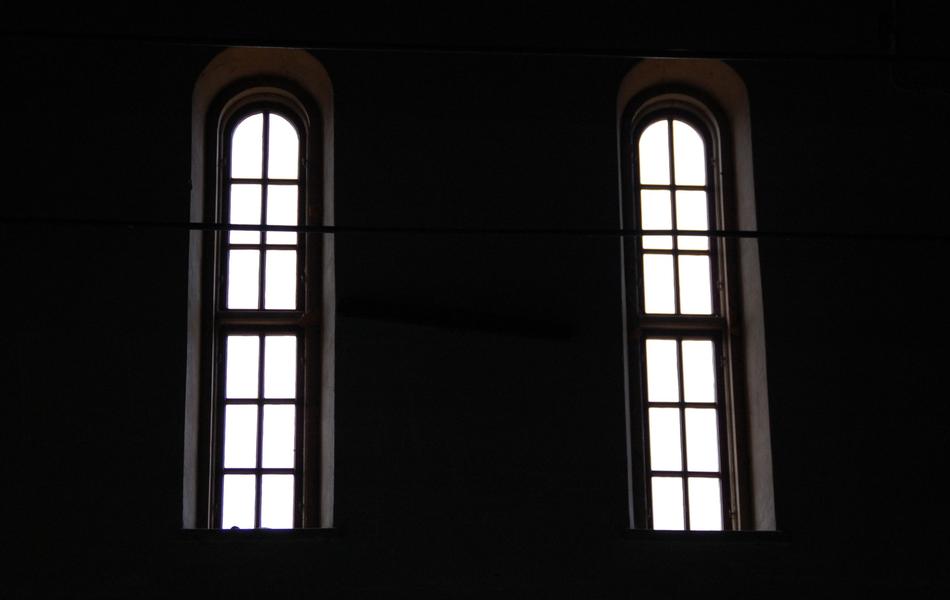 Windows of the building, with white light, among the darkness