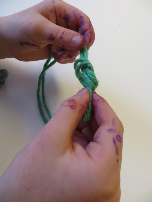 Close-up of the green yarn in the hands of a person