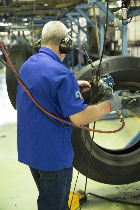 tire recycling, worker in workshop