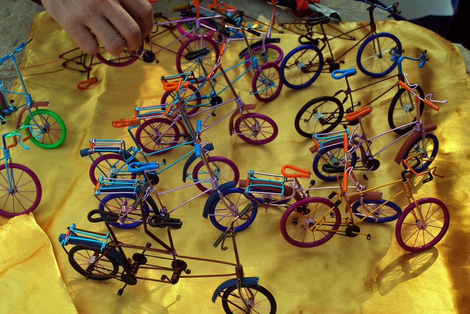 Colorful bicycle figures on the yellow surface