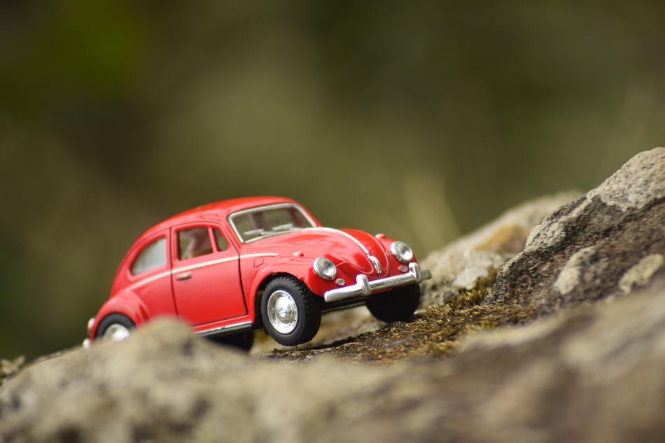 model of a red car in the mountains on a blurred background