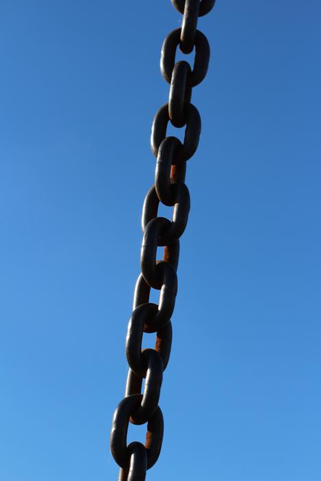Close-up of the shiny chain, at blue sky on background