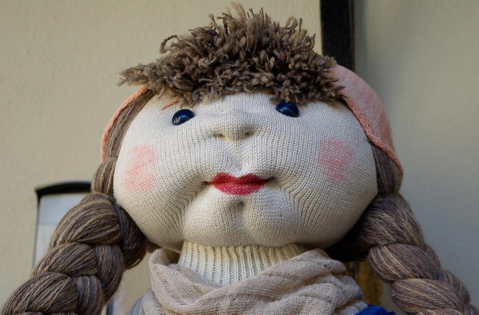Cute and colorful, wool doll, with the breads