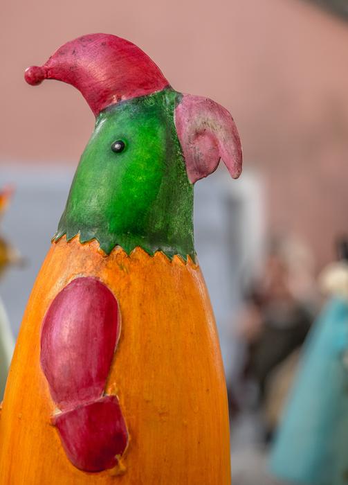Figure of the colorful, beautiful and cute parrot in red hat