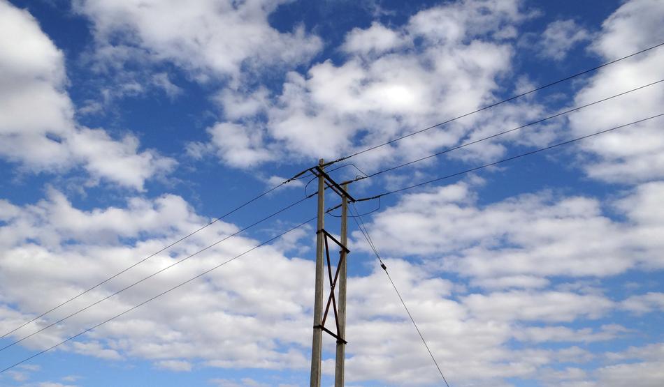 powerful electric towers in the background of clouds