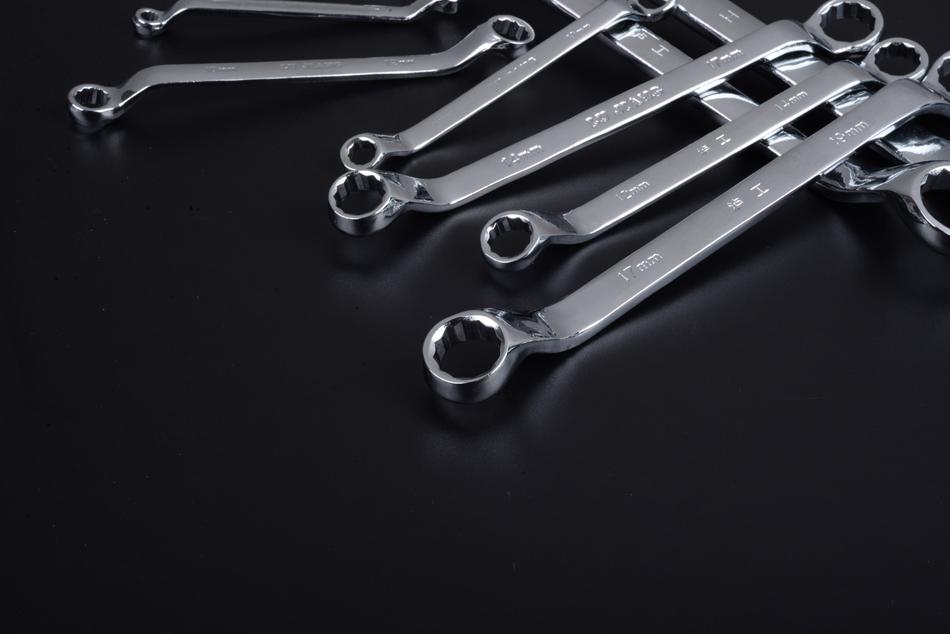 metal wrenches on black background
