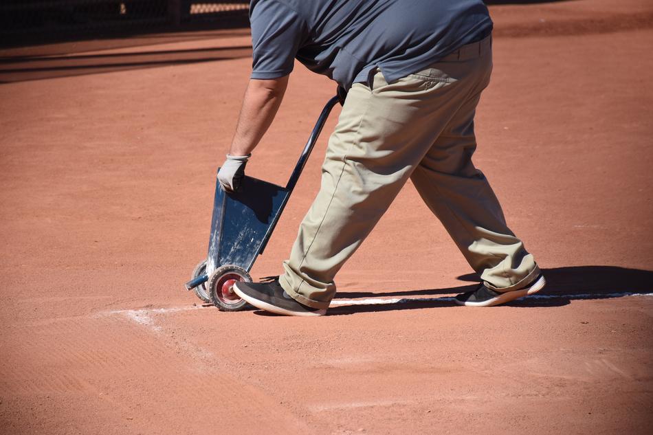 Person, on the the baseball field, with the basket