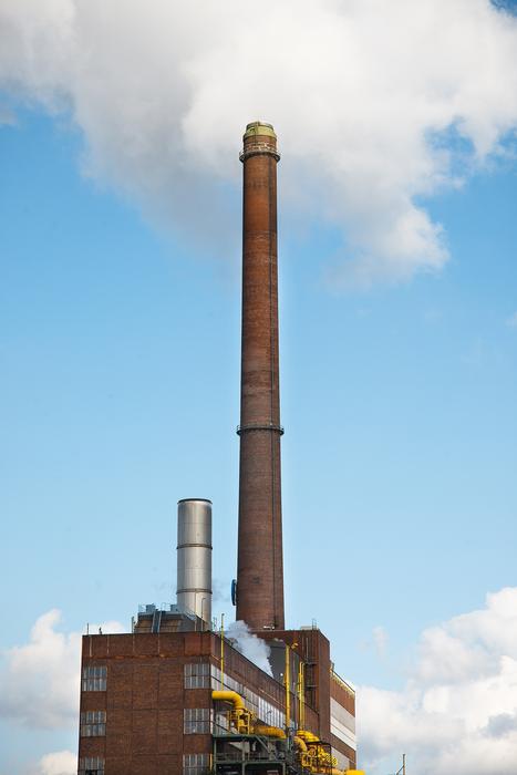 Industrial factory with the pipes, under the blue sky
