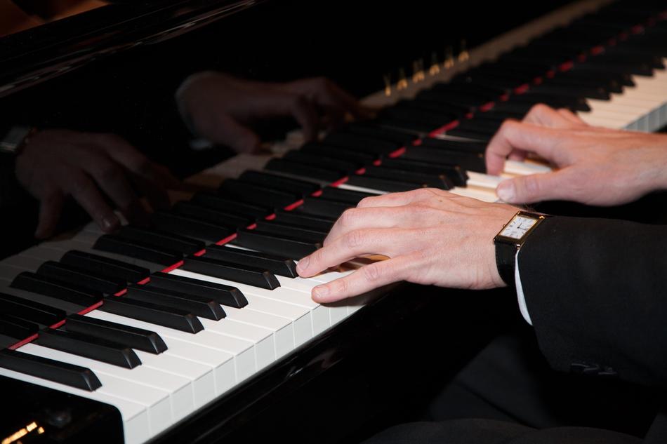 male Hands on Keyboard of Piano