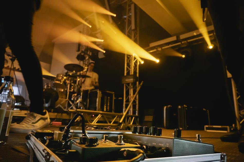 Band on the stage with orange and yellow lights, on the festival