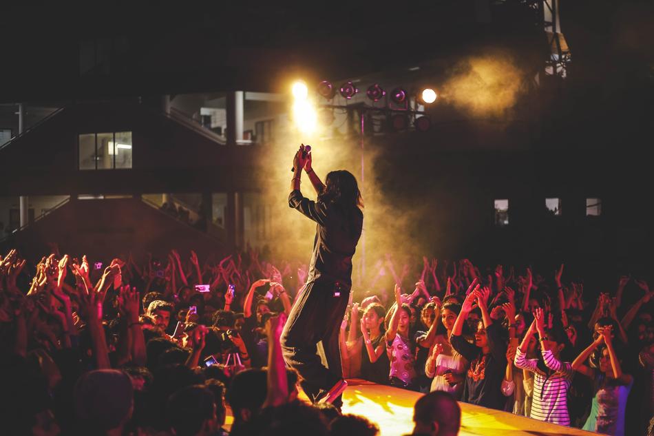 the entertainer welcomes the crowd on stage