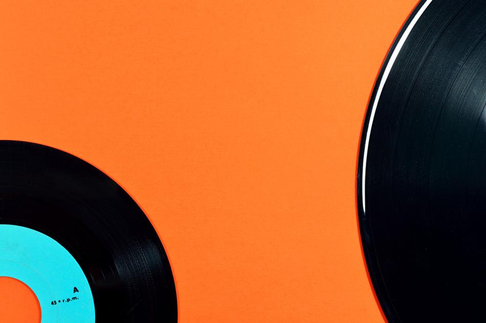 Black and blue retro discs at orange background