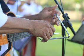 band musician playing triangle instrument