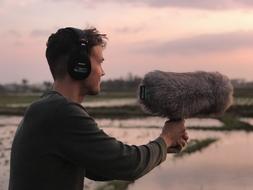 young man makes field recording in Vietnam