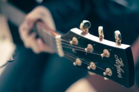 acoustic guitar in human hands