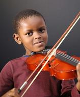 dark skin child boy with Violin