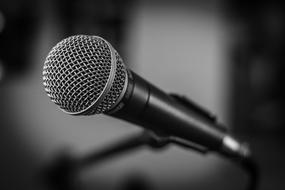 Black and white photo of close-up of the beautiful microphone at blurred background