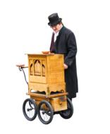 Man in black suit and cylinder hat, near the wooden barrel organ, clipart