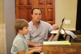 senior musician listening child boy plays Piano