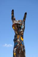 Hard-Rock, hand sign, painted sculpture at sky