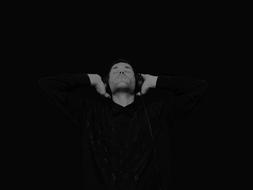 photo of a young man with headphones in the dark