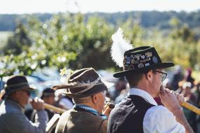 Brass band, playing on the musical instruments, among the green plants, on the beautiful landscape in Bavaria, Germany