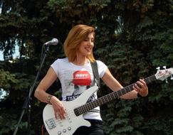 Musician, happy redhead girl plays Guitar outdoor