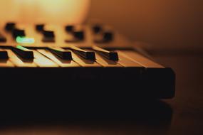 Music Keyboard with green Lamp at dusk