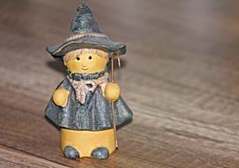 Beautiful, cute and colorful shepherd figure on the wooden surface in light