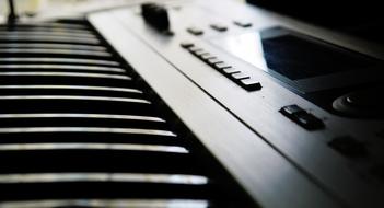 macro photo of the keys of a black synthesizer