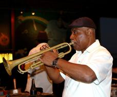 dark-skinned musician with trumpet at an outdoor performance in Havana, Cuba