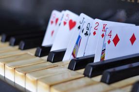 playing cards on piano keys