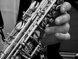 saxophone in man's hands close-up on blurred background