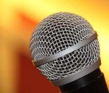 round microphone on blurred colorful gradient background