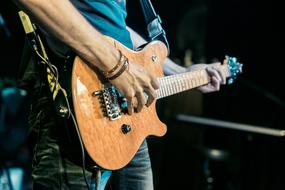 musician with an electric guitar on stage