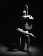 asian musician with guitar, black and white
